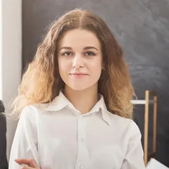Young woman with long curly hair in a white shirt